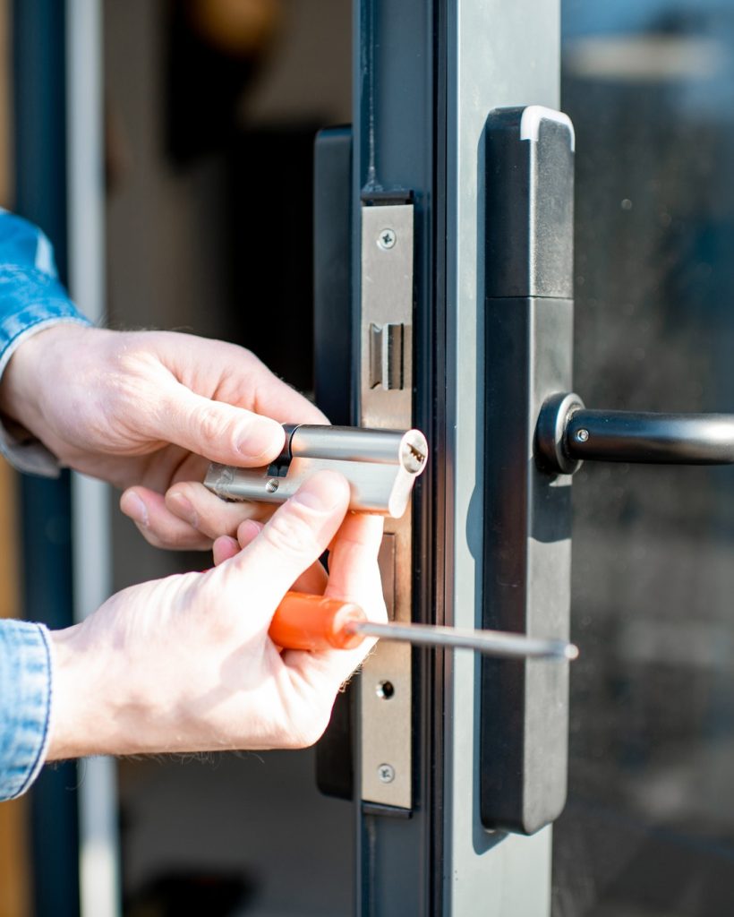 Man changing core of a door lock